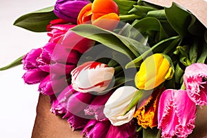 Bouquet of spring multicolor tulips flowers wrapped in gift paper