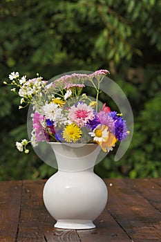 Bouquet of summerflowers on garden table