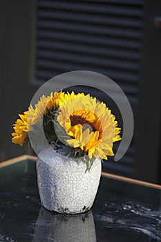 Bouquet of sunflowers in old ceramic jug