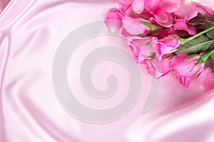 a bouquet sweet pink roses petal on soft pink silk fabric , romance and love card concept