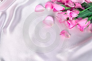 bouquet sweet pink roses petal on soft pink silk fabric , romance and love card concept