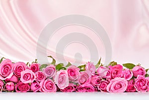 a bouquet sweet pink roses petal on soft white silk fabric ,