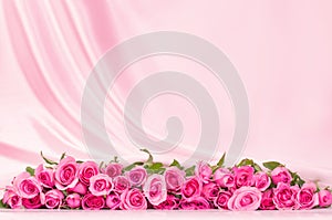 a bouquet sweet pink roses petal on soft white silk fabric ,