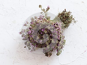 Bouquet of thyme flowers on old wooden board