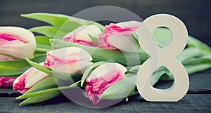 Bouquet of Tulips on dark rustic wooden background. Spring flowe