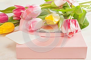 Bouquet of tulips, gift box and blank greeting card
