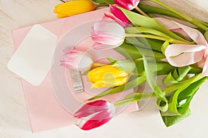Bouquet of tulips, gift box and blank greeting card