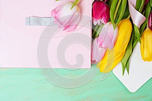 Bouquet of tulips, gift box and blank greeting card