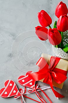 Bouquet of tulips, gift box and decorative hearts for Valentine`s, Women`s or Mother`s day