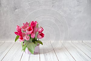 A bouquet of tulips on a gray concrete background