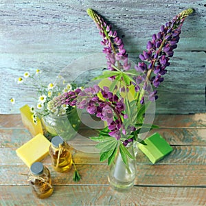 Bouquet of useful herbs and flowers, natural soap, aromatic oil