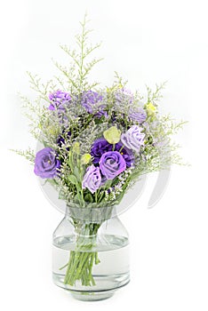 bouquet of violet roses on glass flower vase on white isolated b