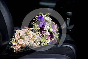Bouquet of wedding flowers on the car seat