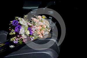 Bouquet of wedding flowers on the car seat
