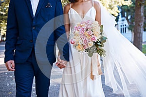 Bouquet, wedding and love of bride, groom and outdoor photograph at celebration, event or reception. Roses, flowers and