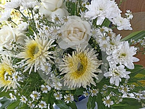 Bouquet of white chrysanthemum with roses and daisy flowers background.