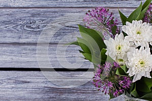 Bouquet of white chrysanthemums and purple allium.