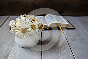 Bouquet of white daisies and bible