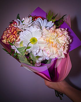 Bouquet with white Daisy flowers close at hand on a dark purple background