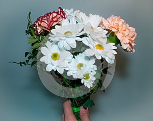 Bouquet with white Daisy flowers close at hand on a green background