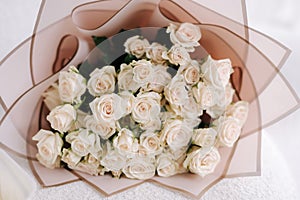 Bouquet of white flowers in gift packaging. reses photo