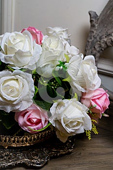 Bouquet of white and red roses in a vase on the table.