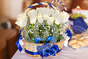 Bouquet of white roses in basket