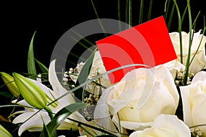 Bouquet of white roses with a business card