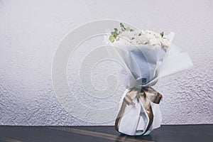 A bouquet of white roses. Flowers in a vase on the table. Wedding