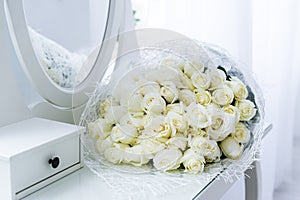 Bouquet of white roses reflected in the mirror. Bride`s bouquet