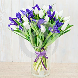 Bouquet of white tulips and blue irises