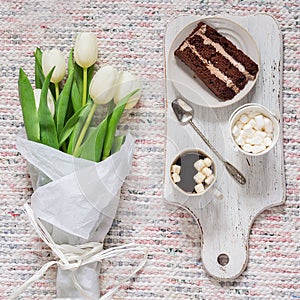 Bouquet of white tulips, coffee and chocolate cake