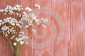 a bouquet of white wildflowers, on a pink background of painted boards, generated by ai, a generative assistant,