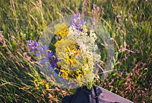 Bouquet of wild flowers in a bag for background