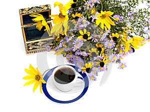 Bouquet of wild flowers, coffee and casket, top view