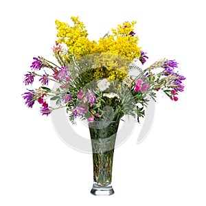 Bouquet of wild flowers in a glass vase isolated on white