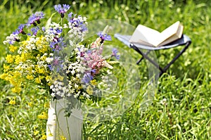 Bouquet of wild flowers and an open book