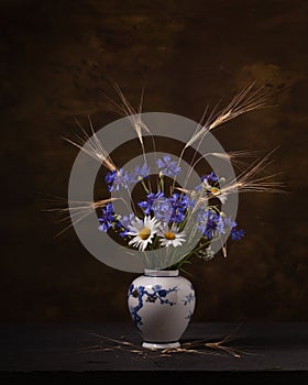 Bouquet of wild flowers in a porcelain vase on a dark background