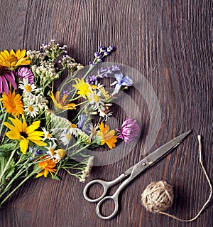 Bouquet of wild flowers scissors vintage board