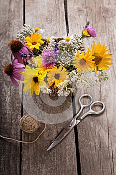 Bouquet of wild flowers scissors vintage board