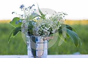 Bouquet of wild flowers at sunset in the field.