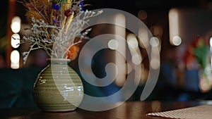 Bouquet of wild flowers in a vase, on a table at a