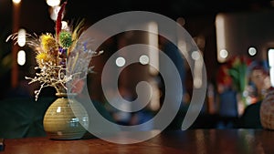 Bouquet of wild flowers in a vase, on a table at a