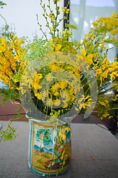 Bouquet with wild yellow flowers and wild fennel in beautiful ha