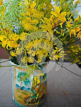 Bouquet with wild yellow flowers and wild fennel in beautiful ha
