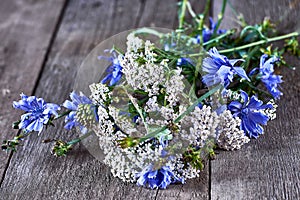 Bouquet of wildflowers against wooden floor