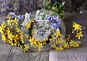 Bouquet of wildflowers against wooden floor