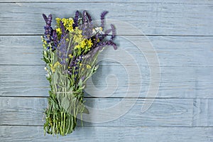 Bouquet of wildflowers on a wooden blue gray background.