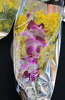 Bouquet of yellow mimosas with an orchid