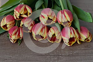 A bouquet of yellow and pink tulips.